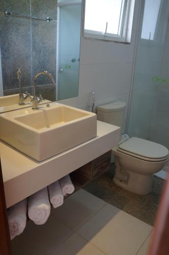 a bathroom with a sink and a toilet at Pousada Aguas Claras in Búzios