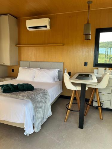 a bedroom with a bed and a table with a desk at Villa D Castro in Gonçalves