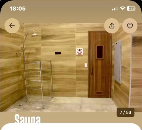 a bathroom with a shower with a towel rack and a door at The Cittyplex Osasco - new flat in Osasco