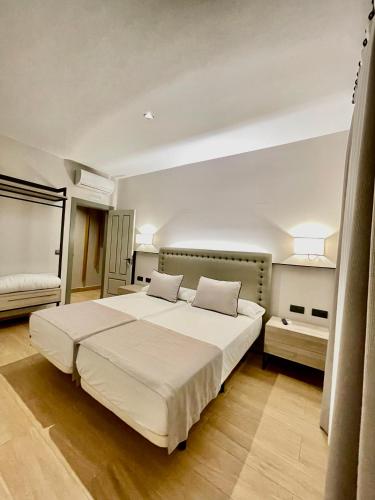 a bedroom with a large white bed with two pillows at Mape Loft Rural ALJIBE in Algar
