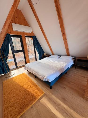 a bedroom with a bed in a attic at A-frame Marisa Vadu Crisului in Vadu Crişului