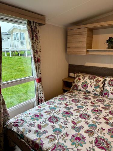 a bedroom with a bed and a window at Chesil View in Wyke Regis