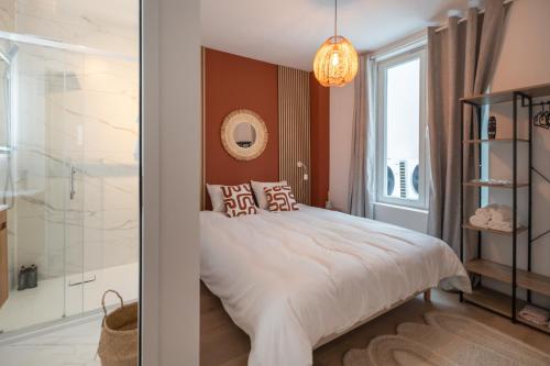 a bedroom with a large bed and a bathroom at Vandenbranden Suites in Brussels