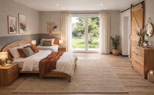 a bedroom with two beds and a large window at Haus der alten Bäume - Retreathaus Hillesheim in Hillesheim
