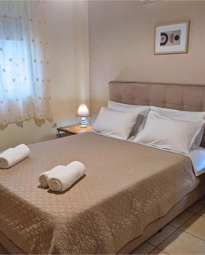 a bedroom with a large bed with towels on it at Panorama Beach in Chrani