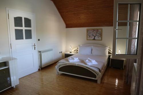 a bedroom with a bed with two white towels on it at Galini Home 2 in Prokópion