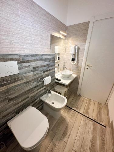 a bathroom with a toilet and a sink at Hotel Dell'Orto in Chiavari