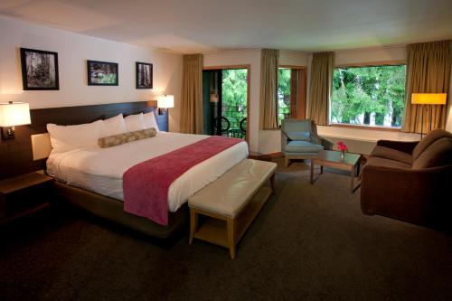 a hotel room with a bed and a chair at Lake Quinault Lodge in Quinault