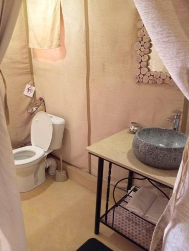 a small bathroom with a sink and a toilet at Merzouga Landscape luxury Camp in Merzouga