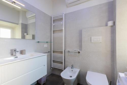 a white bathroom with a sink and a toilet at Casa Germana, Marano Ticino in Marano Ticino