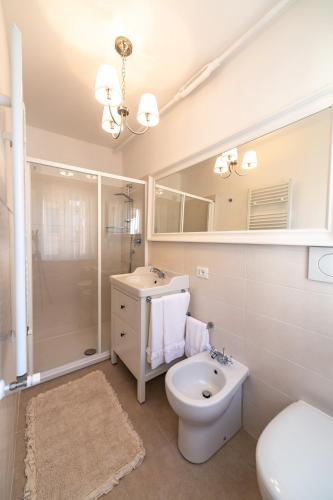 a bathroom with a toilet and a sink and a shower at il risveglio di alice in Fano