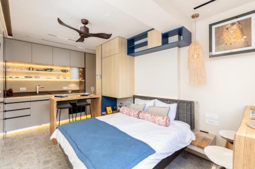 a bedroom with a large bed and a kitchen at Chill out Spa Studio in Kotor