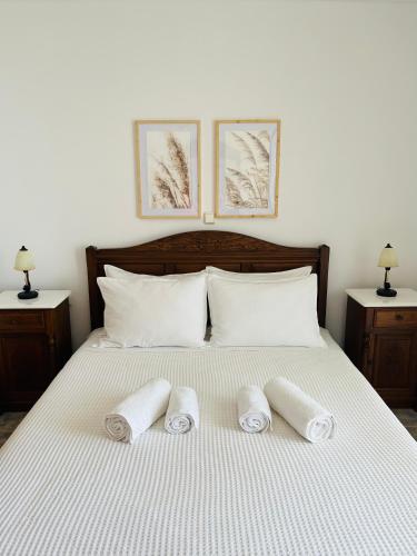 a bedroom with a bed with three towels on it at Villa Di Costa in Nea Skioni
