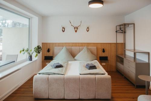 a bedroom with a bed and a large window at Schwarzwald Loft Bergblick in St. Blasien