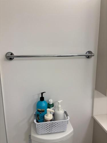 a bathroom with a shelf on the back of a toilet at Executive 2 beds and 1 bath suit in Surrey