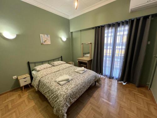 a bedroom with a bed with two pillows on it at Sfiggos 54 Guest House in Athens