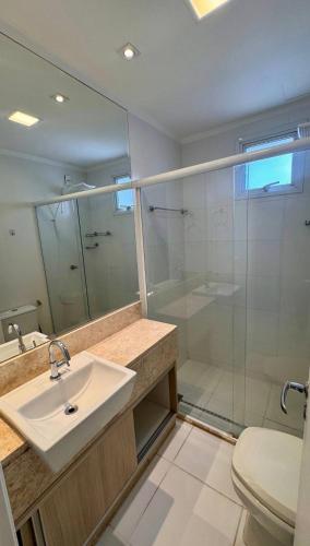 a bathroom with a sink and a glass shower at Metropolitan Mall in Goiânia