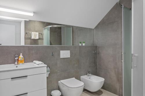 a bathroom with a toilet and a sink and a mirror at House Degenia in Lovinac