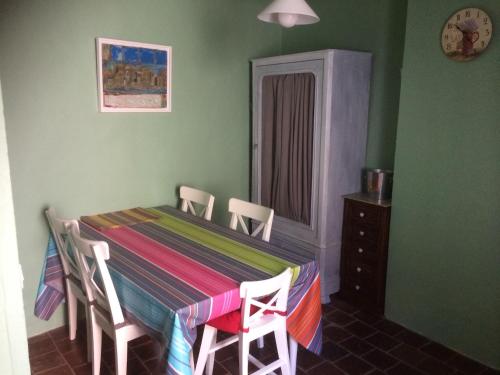 a dining room with a table and chairs and green walls at The Nut House in La Garde-Freinet