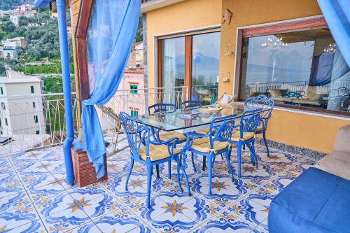 a dining room with a table and chairs on a balcony at The Dreamer's Terrace in Vico Equense