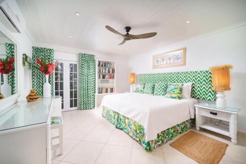 a bedroom with a bed and a ceiling fan at Glitter Bay Apartment 104 in Saint James