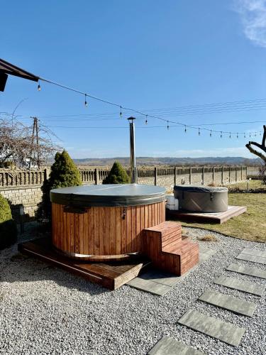 a hot tub and a bench in a yard at Agroturystyka Gorajeckie Roztocze in Górajec Zastawie