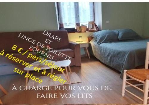 a room with a bed and a chair and a couch at La BK'ne studio 2 à 4 personnes in Villeneuve-en-Retz