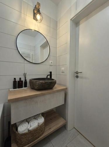 a bathroom with a sink and a mirror at Garden Residence in Nitra