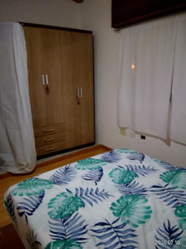 a bedroom with a bed and a closet with a door at Tu hogar en Concordia in Concordia