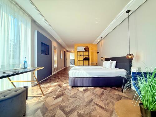 a hotel room with a bed and a desk at Boutique Hotel Zuckerfabrik Stuttgart in Stuttgart