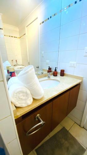 a bathroom with a sink and a mirror at Viabo in Viña del Mar