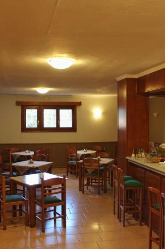 a dining room with tables and chairs in a restaurant at Driades in Kalavrita
