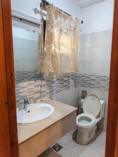 a bathroom with a sink and a toilet at The Aristocrat Manor in Islamabad