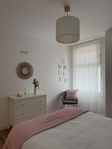 a bedroom with a bed and a dresser and a chair at Bruma in Vilagarcia de Arousa