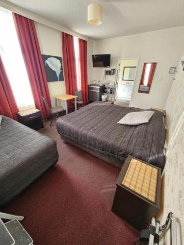 a hotel room with a bed and a table in it at Masonic Hotel in Palmerston North