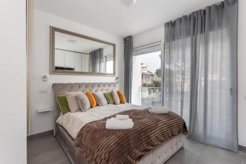 a bedroom with a large bed and a large window at Luxury beach front in Torre Grande
