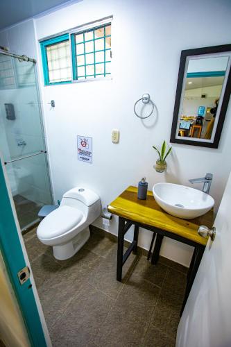 a bathroom with a toilet and a sink and a mirror at Finca La Molienda, espléndido Mirador del Quindio in Circasia