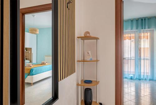 a room with a mirror and a bedroom with a bed at Perla del Salento in Brindisi