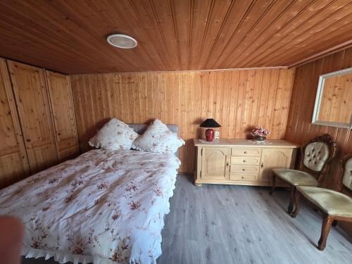 a bedroom with a bed and a wooden ceiling at Ferienwohnung Sonne in Bad Staffelstein