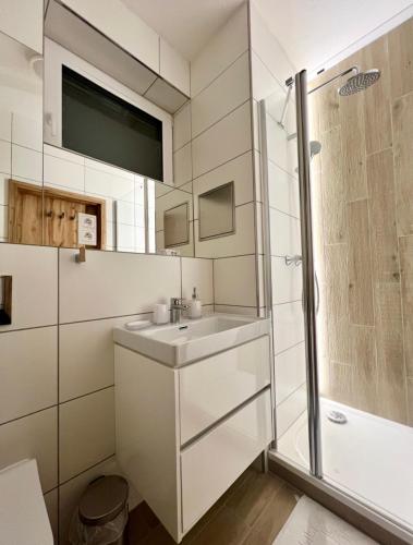 a bathroom with a sink and a shower at Apartmány Stagnum Liptovský Ján in Liptovský Ján