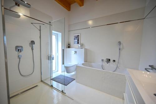 a bathroom with a shower and a sink and a toilet at Villa OLIVA in Kľačany