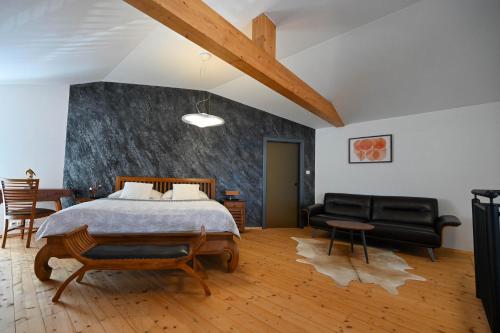 a bedroom with a bed and a living room at Villa OLIVA in Kľačany