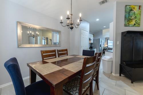 a dining room with a table and chairs and a bathroom at Modern Updates - Great Location - King Bed- BMT in San Antonio