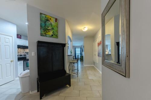 a living room with a fireplace and a mirror at Modern Updates - Great Location - King Bed- BMT in San Antonio