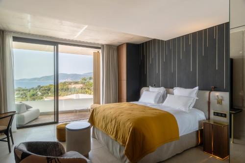 a bedroom with a large bed and a large window at Villa Urbana in Porticcio