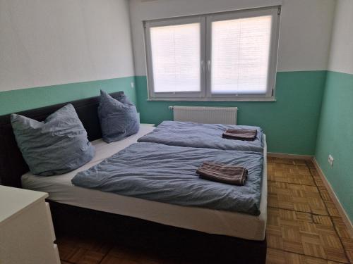 a bedroom with a bed with two pillows on it at Wolfskraft in Hauenstein