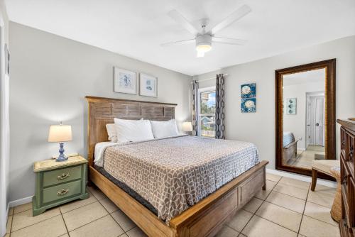 a bedroom with a bed and a mirror at 5 Star 30 Steps from Beach l 3m Walk to Rest & Shops in Clearwater Beach