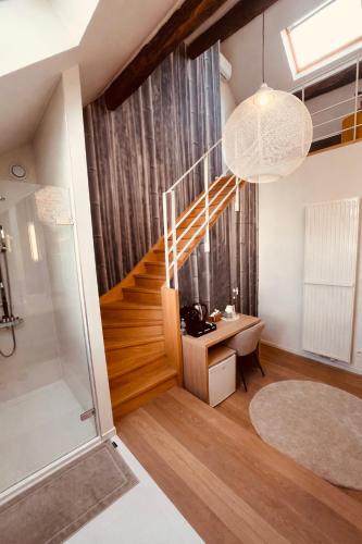a room with a staircase with a desk and a glass door at DEUXHOMMES Boutique B&B Massage&Spa in Hasselt