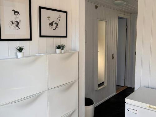 a room with a white dresser and a mirror at 4 star holiday home in Juelsminde-By Traum in Sønderby