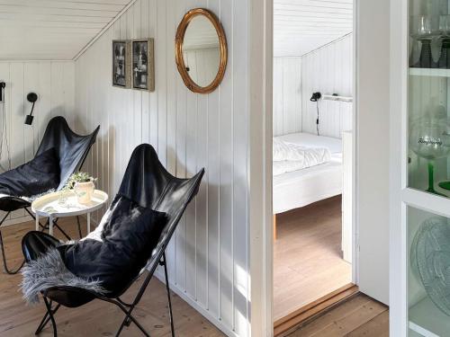 a room with two chairs and a table and a bed at 4 star holiday home in Juelsminde-By Traum in Sønderby